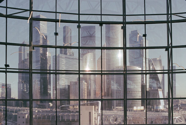 Reflection of a neat cityscape on a perfectly cleaned high-rise office window.