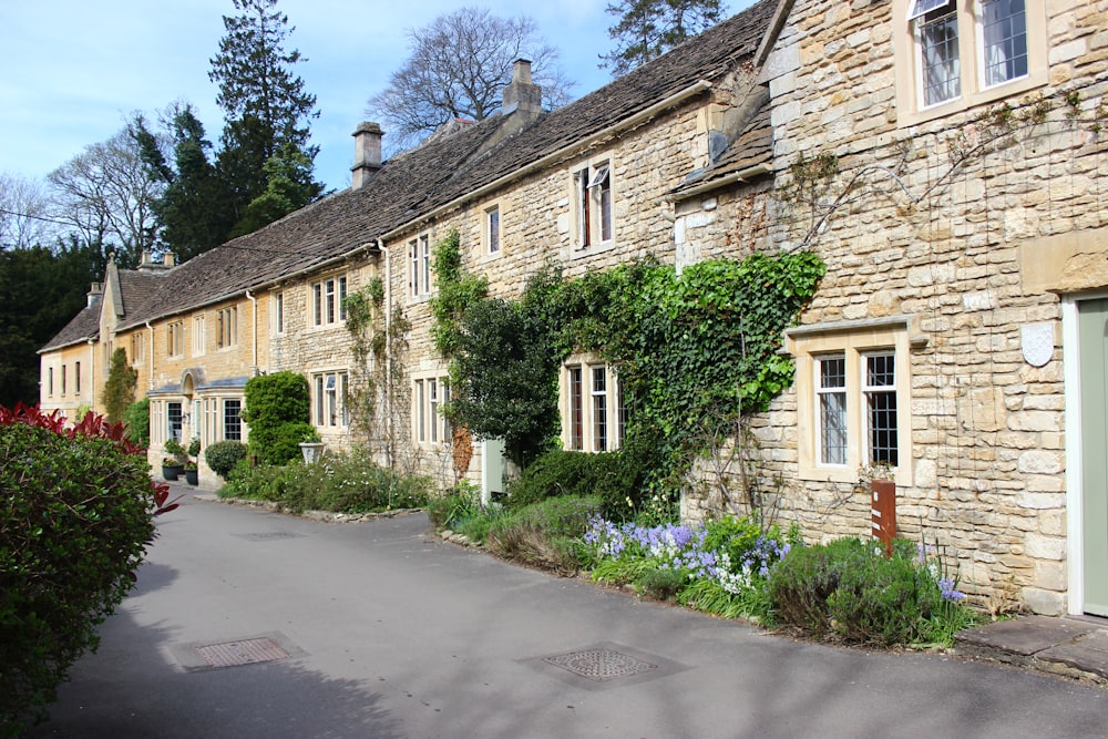 a stone building with a green door and windows