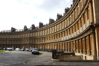 a curved building with cars parked in front of it