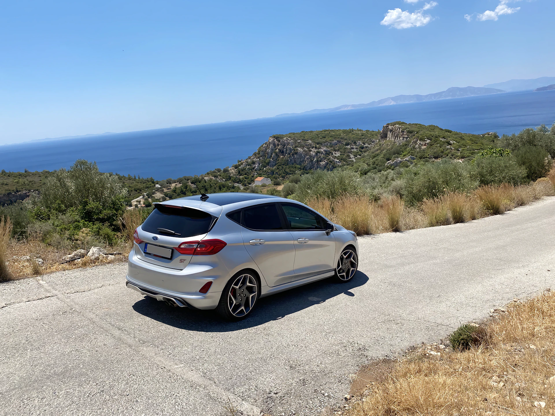 White Ford Fiesta parked beside a road