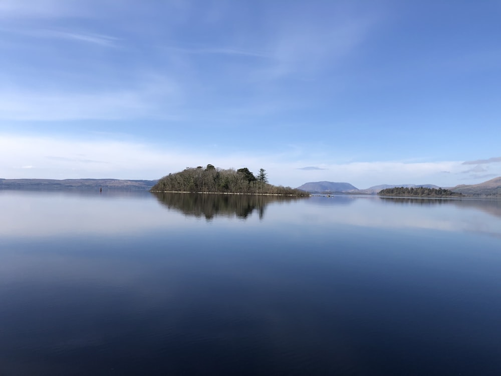 a large body of water with a small island in the middle of it