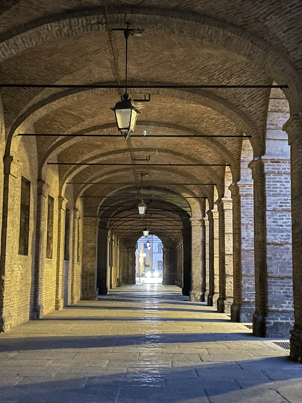 a long hallway with a light hanging from the ceiling