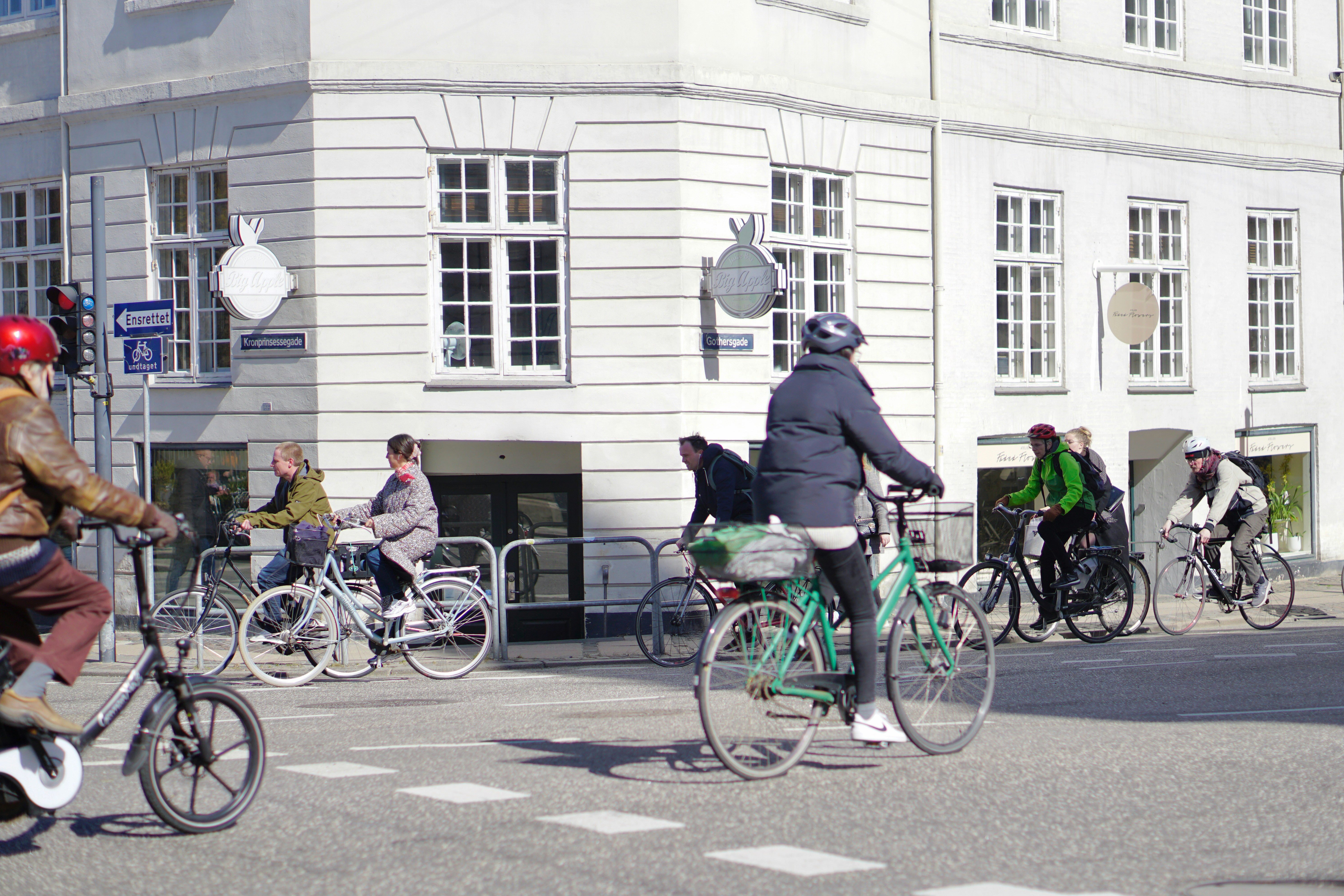 a group of people riding bikes down a street