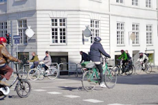 a group of people riding bikes down a street