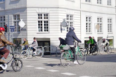 a group of people riding bikes down a street