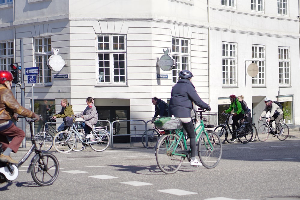 a group of people riding bikes down a street