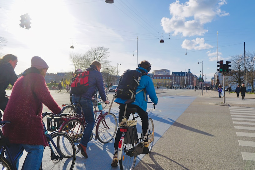 A bustling city street with modern urban mobility solutions like bike lanes and smart traffic lights.