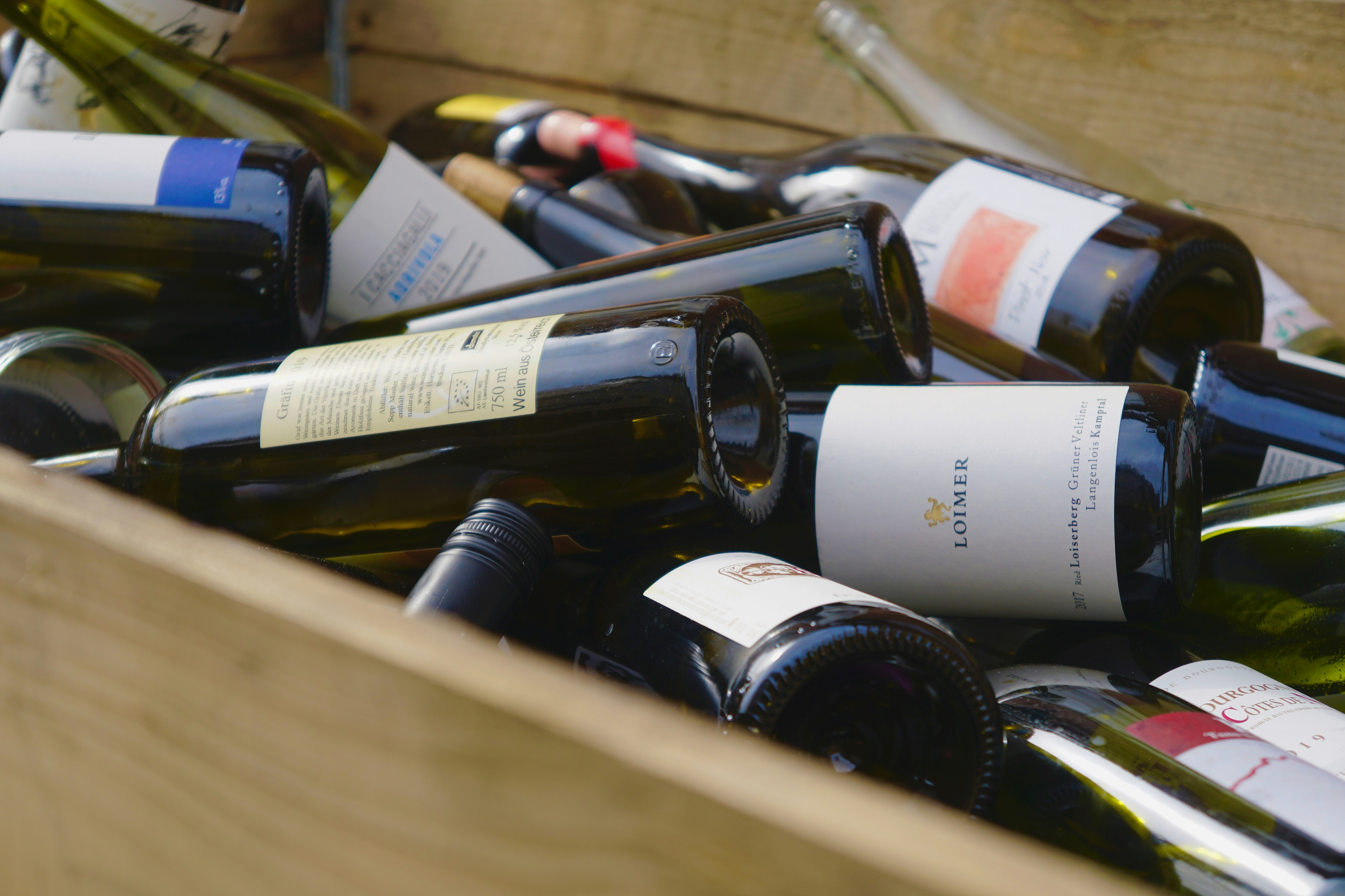 a wooden box filled with lots of bottles of wine