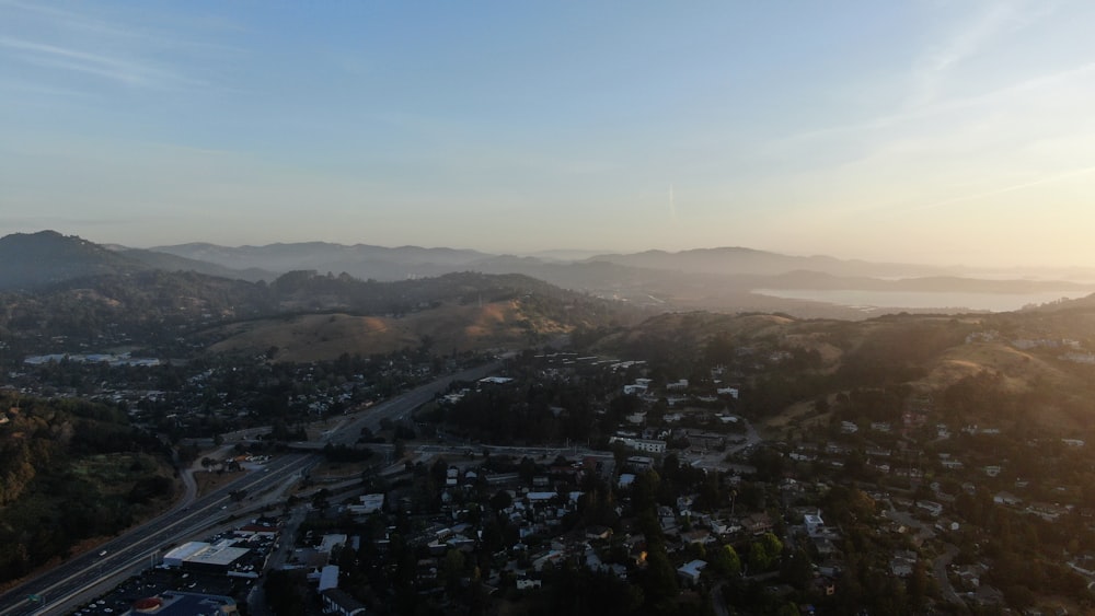 an aerial view of a city with mountains in the background