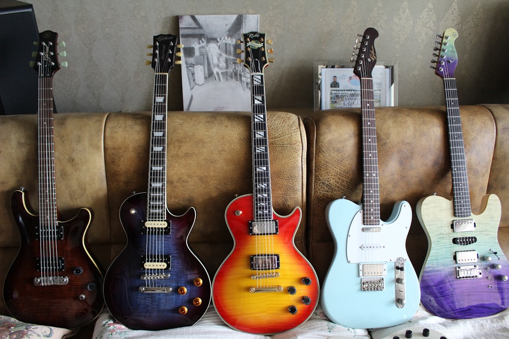 a group of guitars sitting on top of a couch