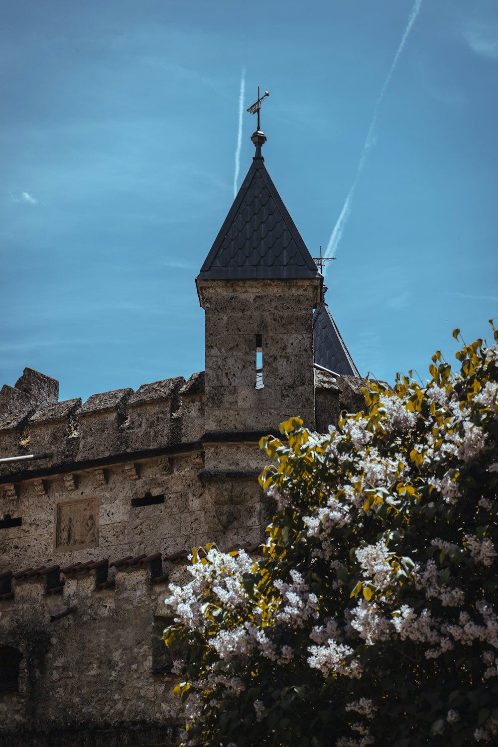 a tall tower with a cross on top of it