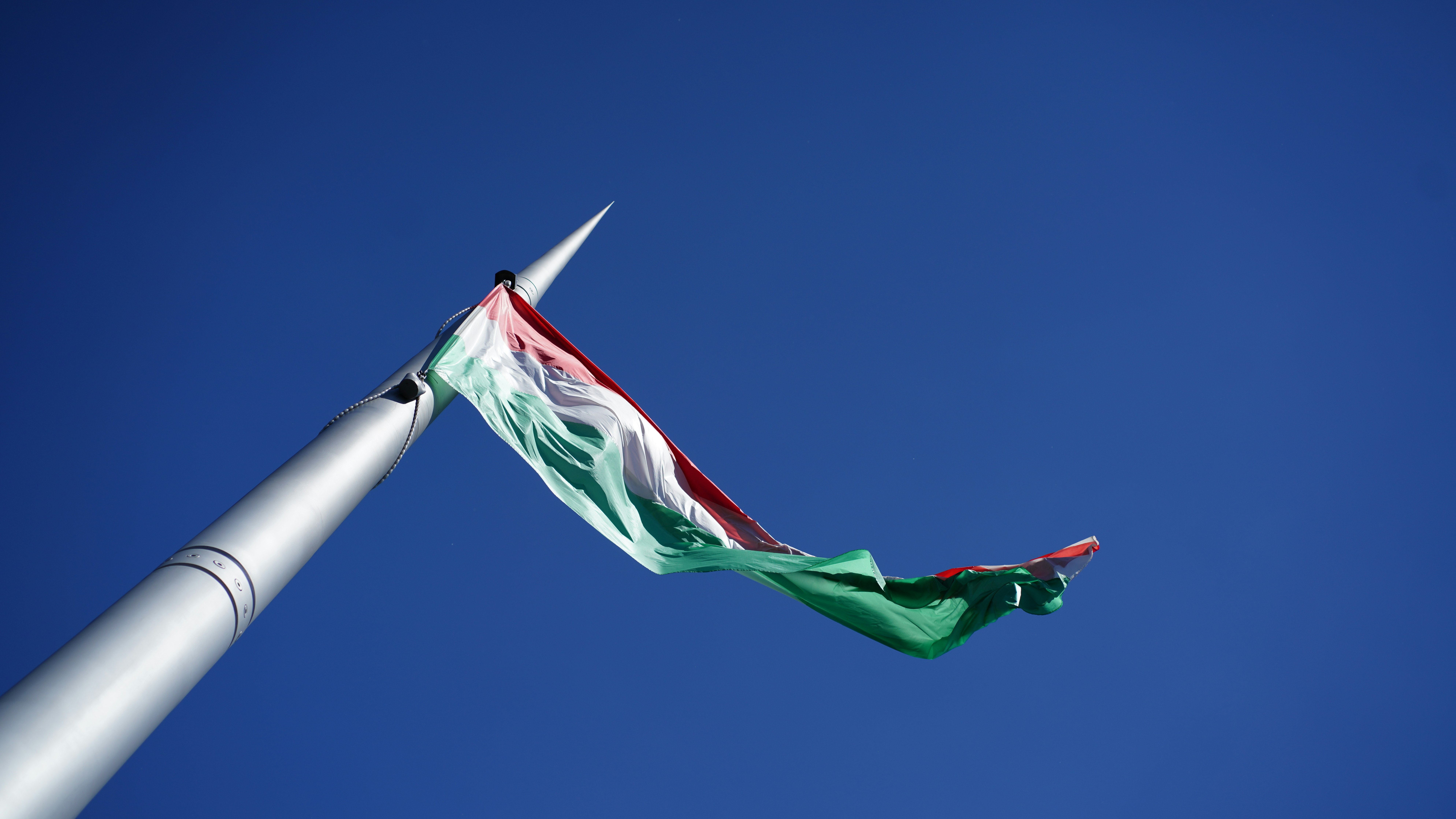A green, white, and red flag flying in the wind photo – Free Toy Image ...