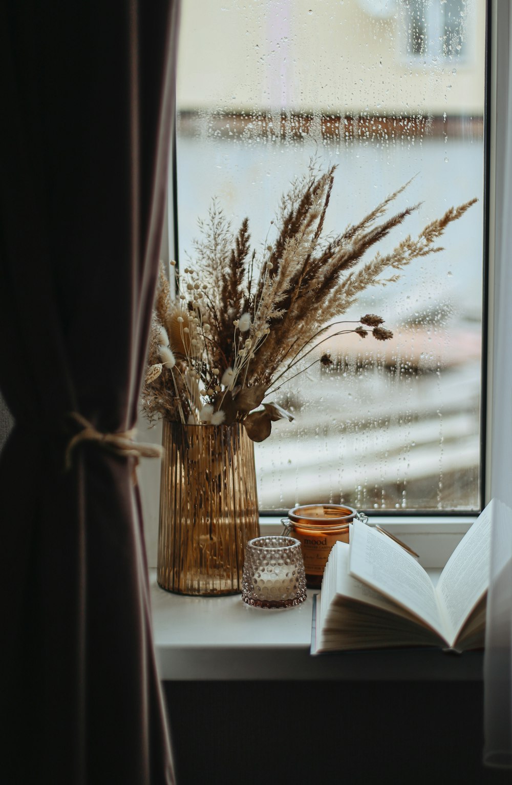 a vase of flowers sitting on a window sill