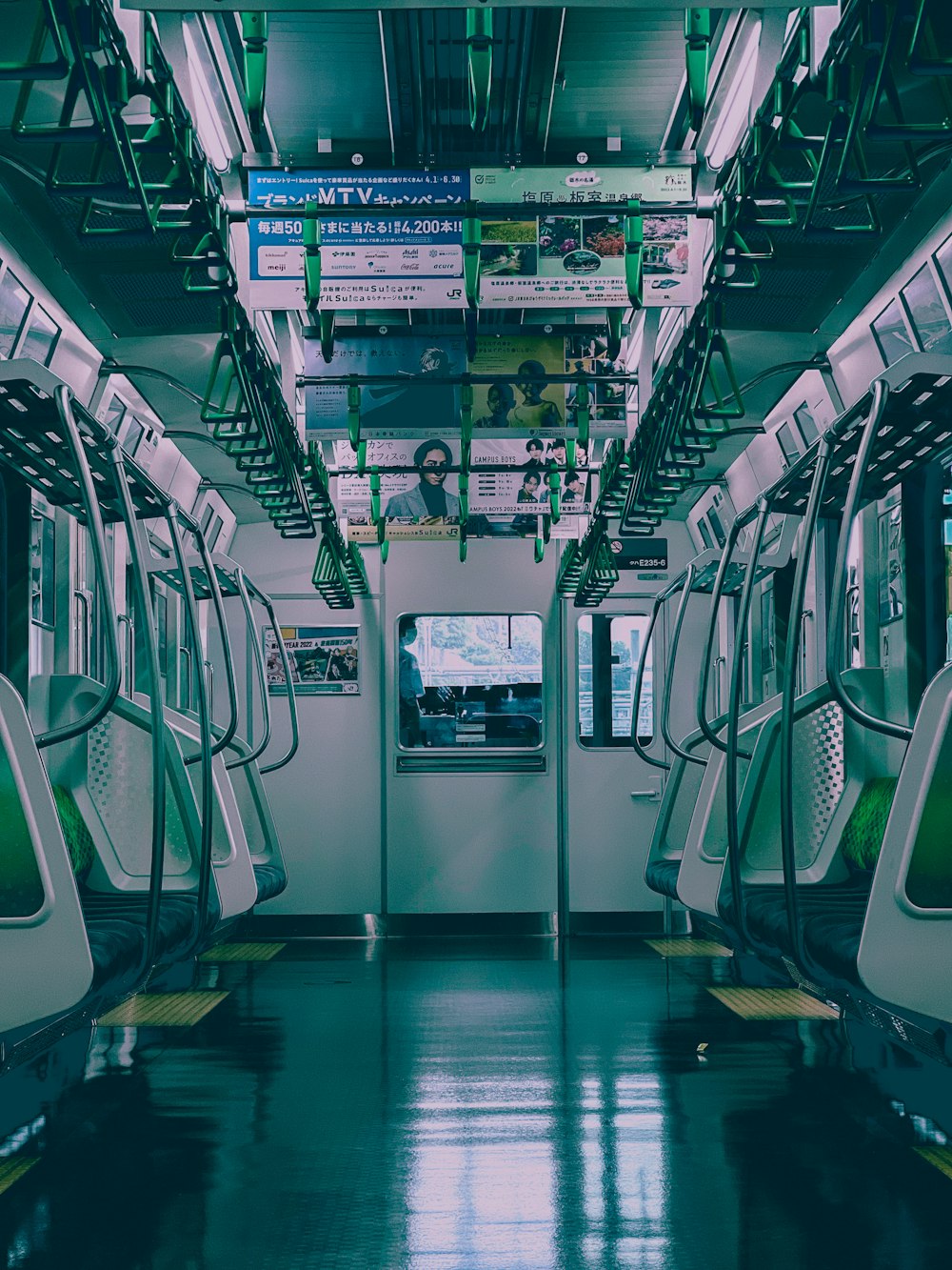 the inside of a subway car with green trim