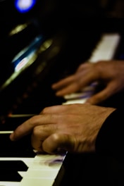 a person playing a piano with their hands
