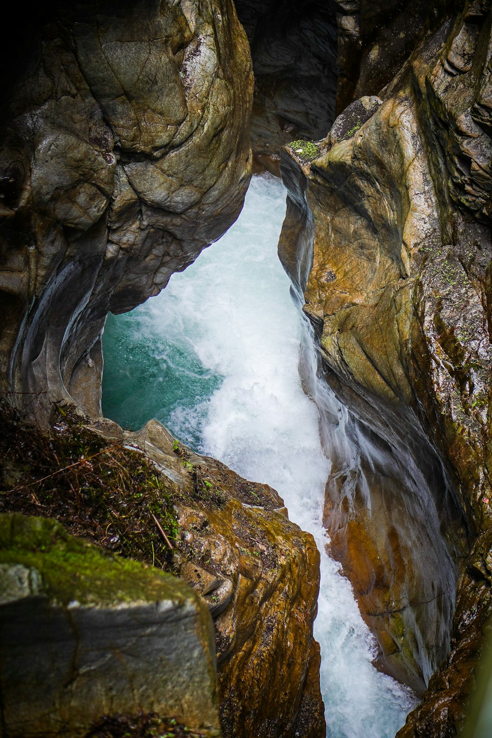 a river running through a cave in the woods