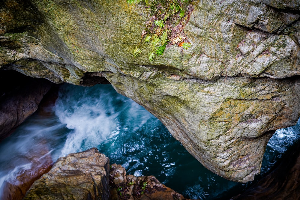 a large rock formation with water coming out of it