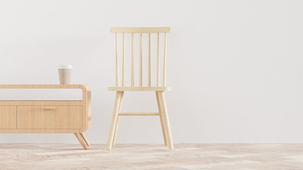 a wooden chair next to a bed in a room