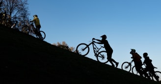 Group of riders climbing a steep hill with the Ibiza landscape in the background.