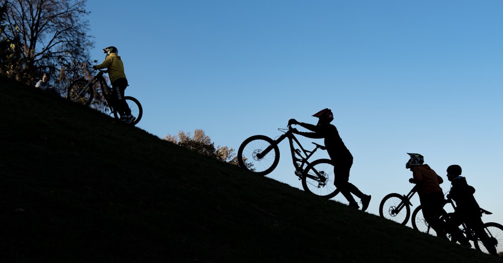 a group of people riding bikes down a hill