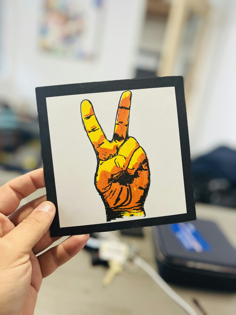 a person holding up a picture of a peace sign