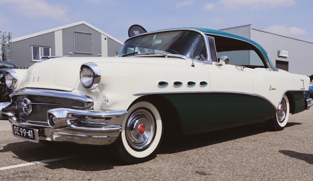 a white and green car parked in a parking lot