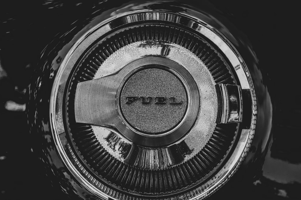 a black and white photo of the emblem of a car