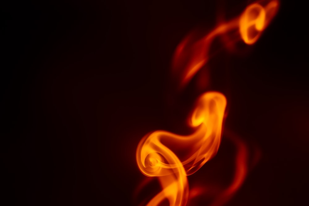 a close up of a red fire on a black background