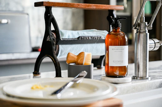 a bottle of liquid sitting on top of a sink