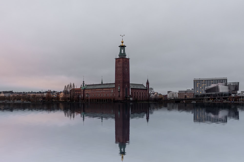 a clock tower in the middle of a body of water