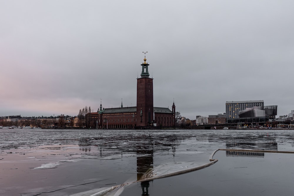 a clock tower in the middle of a body of water