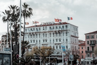 a large white building with flags on top of it
