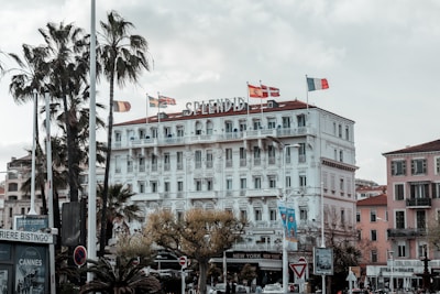 a large white building with flags on top of it