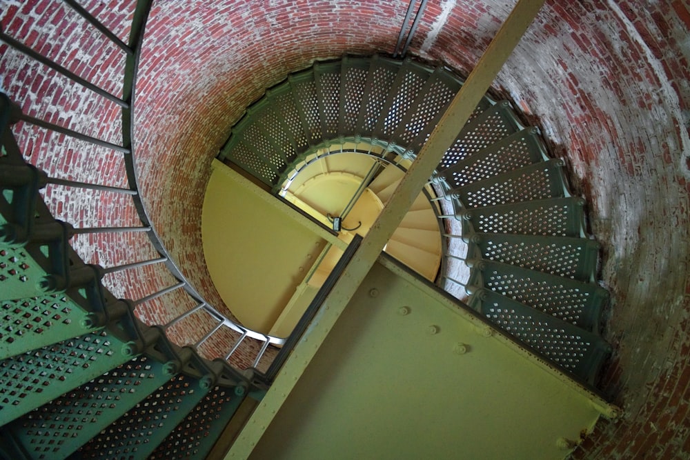 a spiral staircase in an old brick building