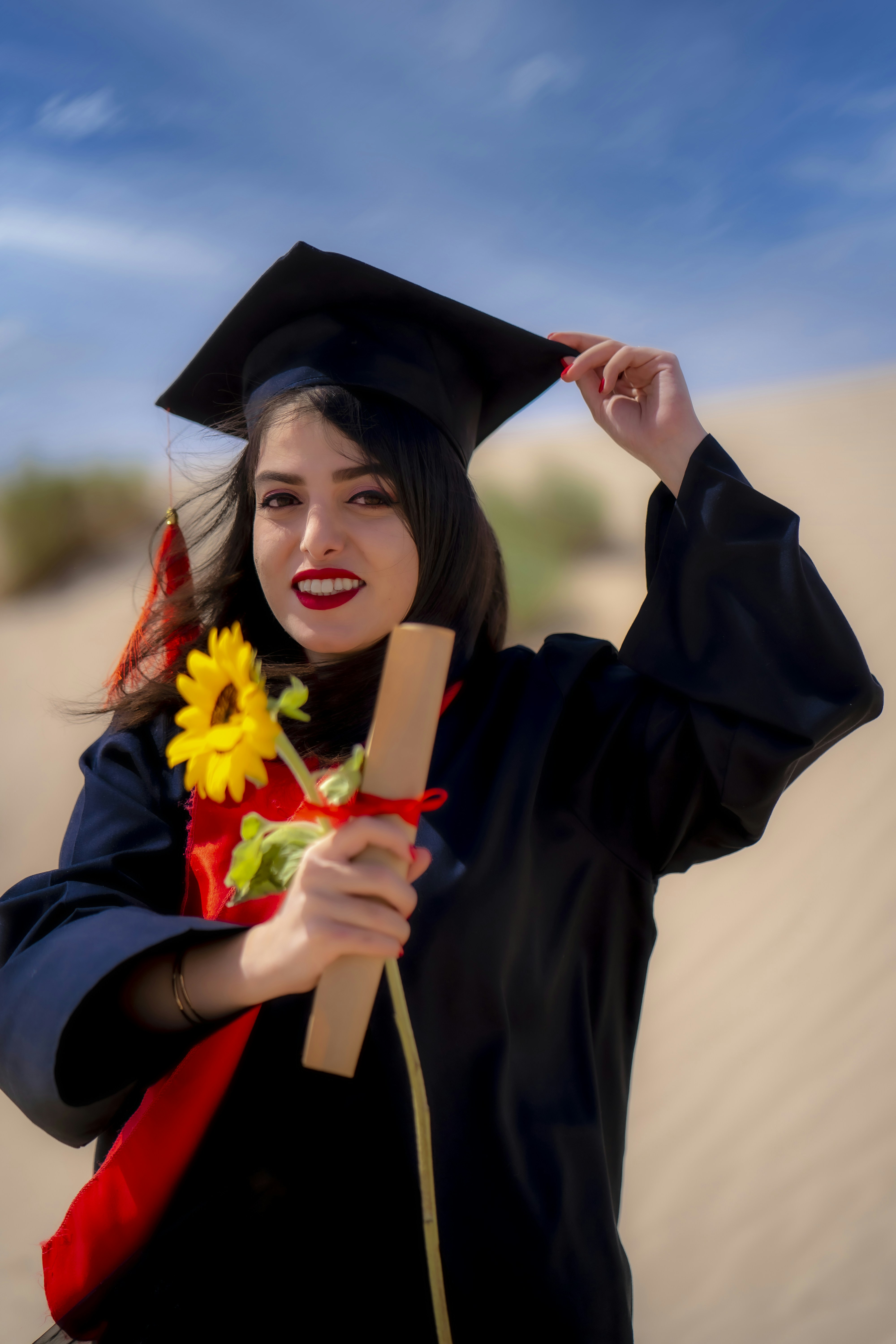 a woman in a graduation gown holding a diploma