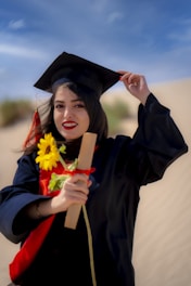 a woman in a graduation gown holding a diploma