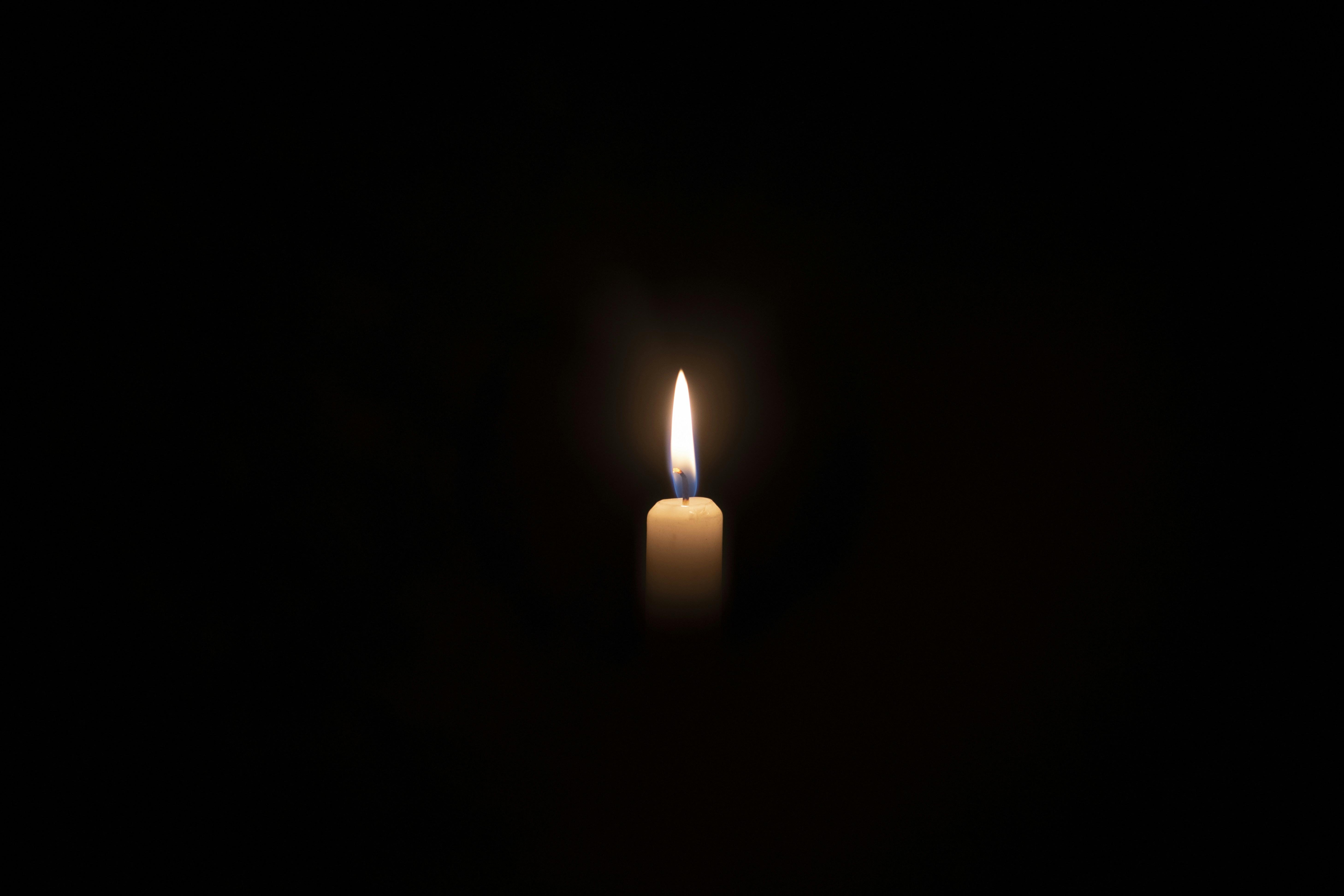 A single candle is lit in