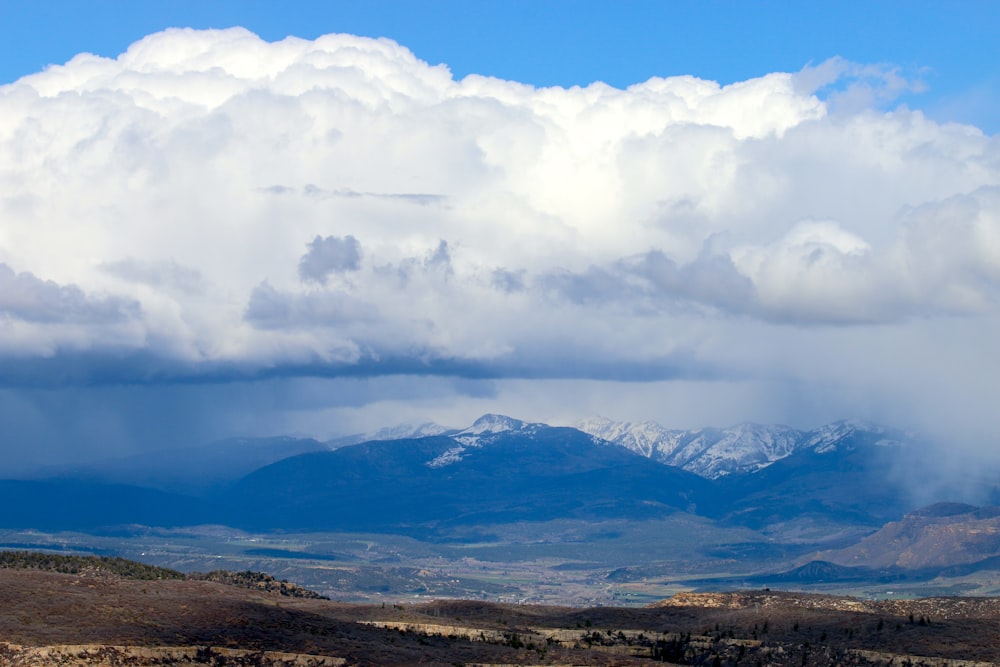 a view of a mountain range under a cloudy sky