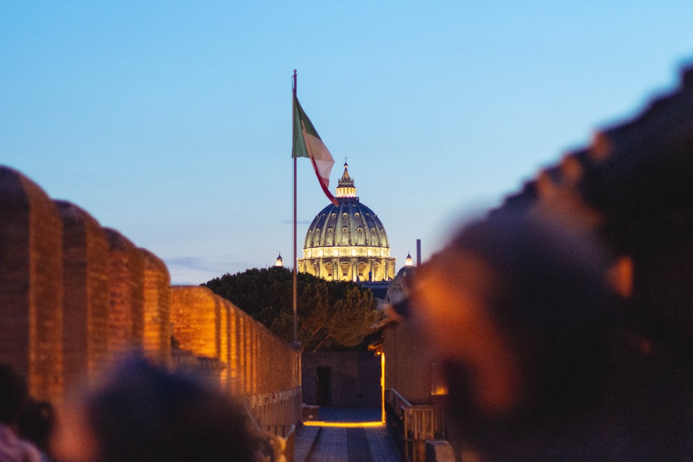 a building with a dome and a flag on top of it