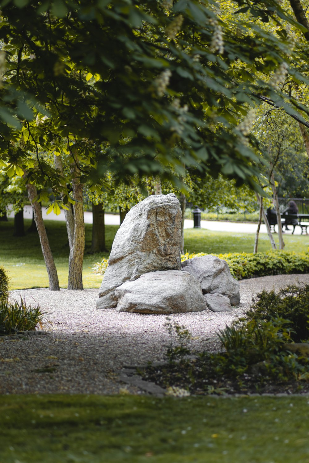 a large rock sitting in the middle of a park