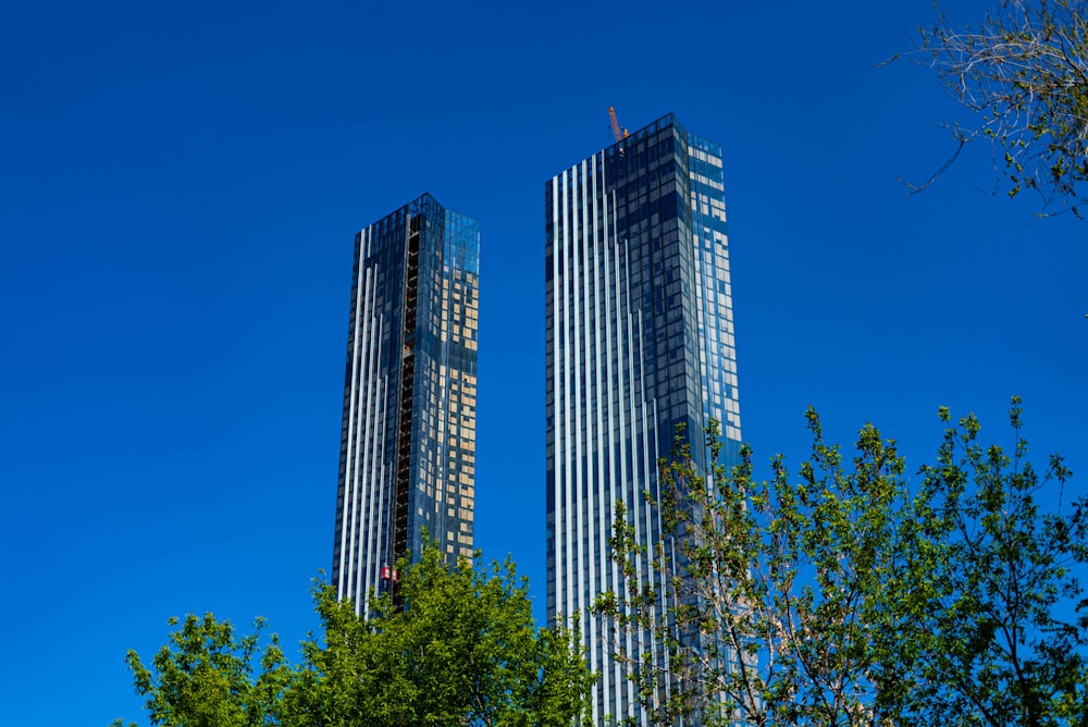 a couple of tall buildings sitting next to each other