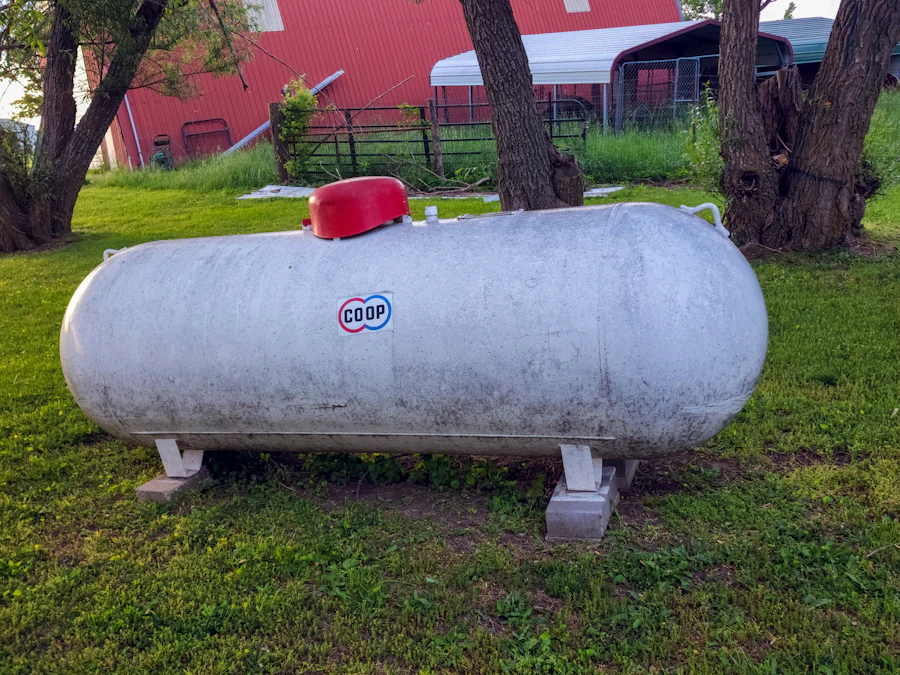 A propane tank on the lawn of a working farm