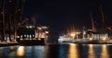 a large cargo ship in a harbor at night