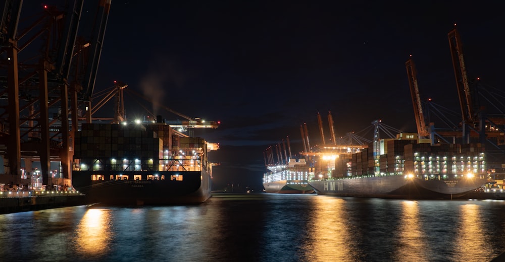 a large cargo ship in a harbor at night