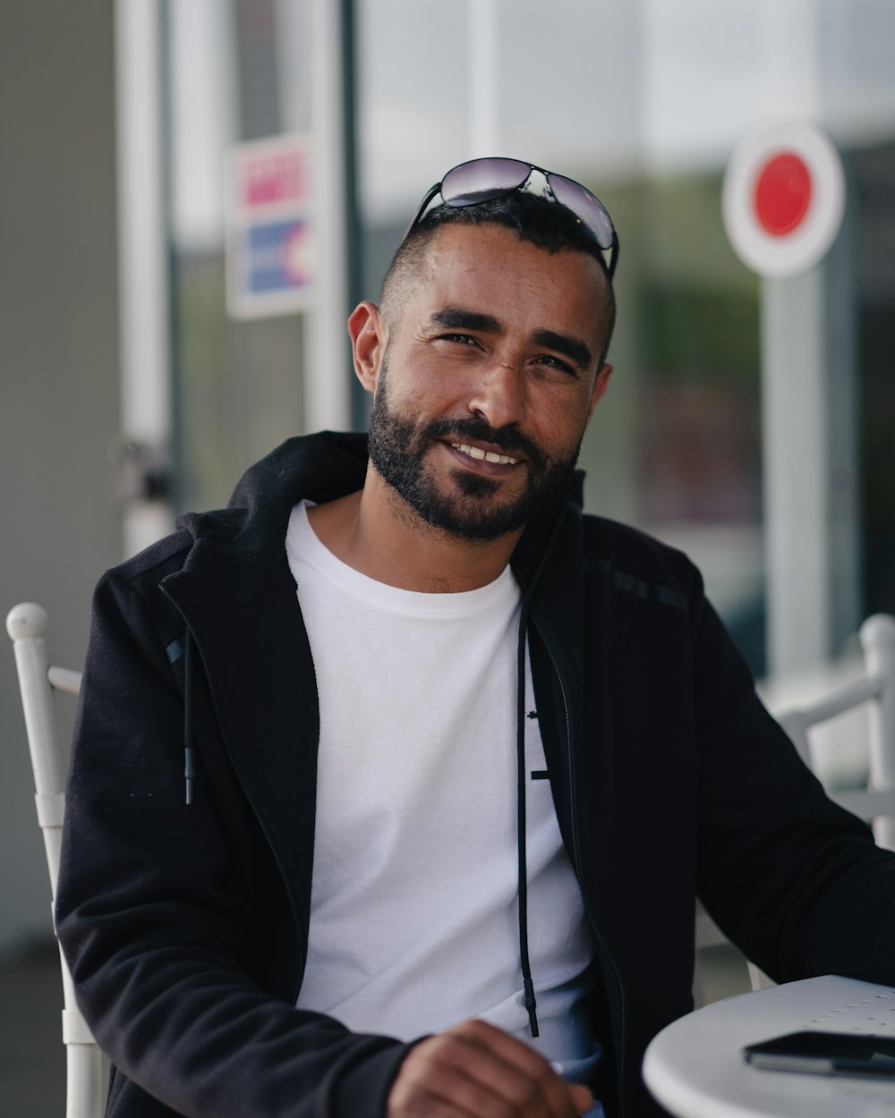 a man with a beard sitting at a table