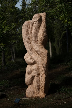 a sculpture of a woman holding a baby in her arms