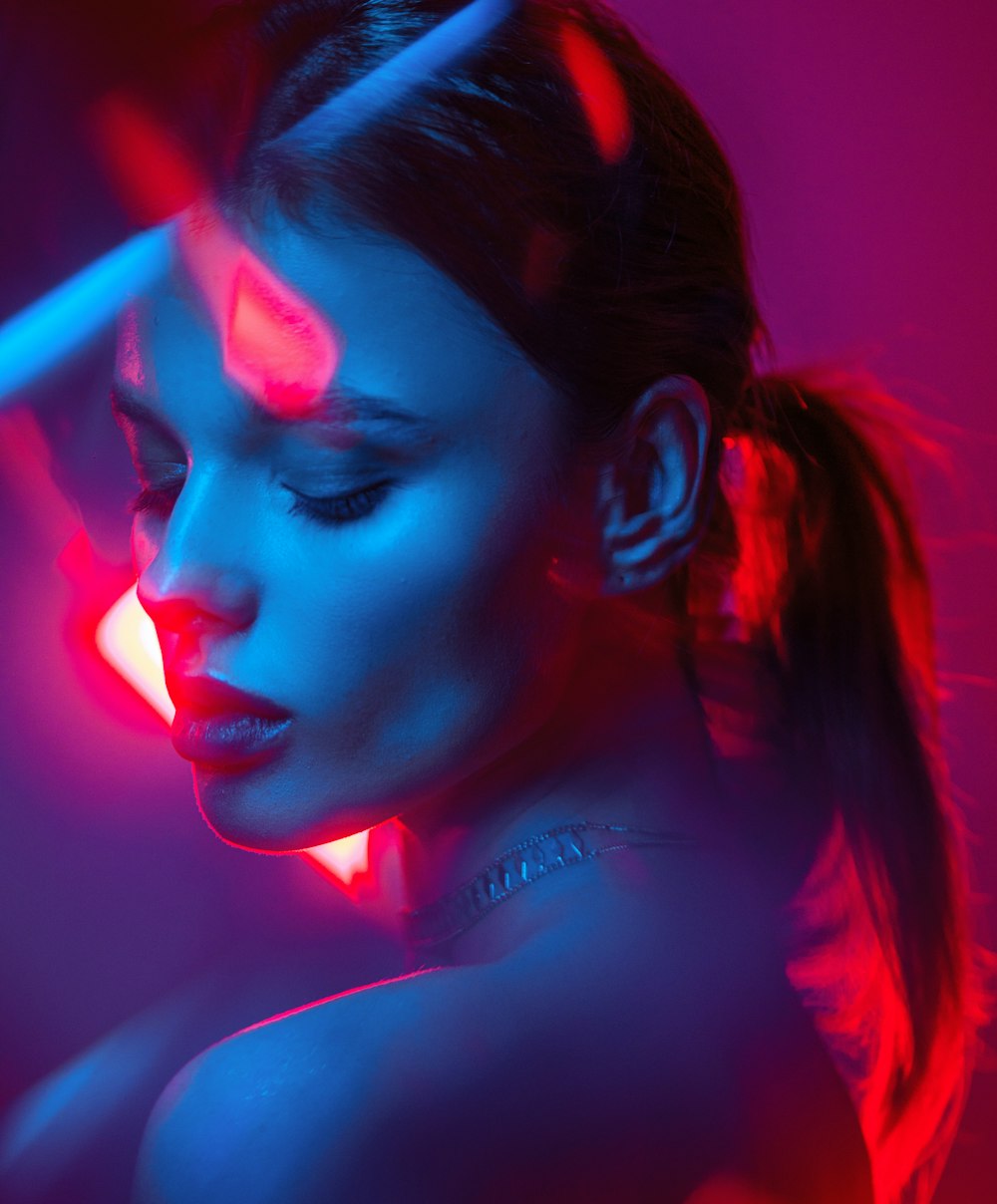 a woman in a dark room with neon lights