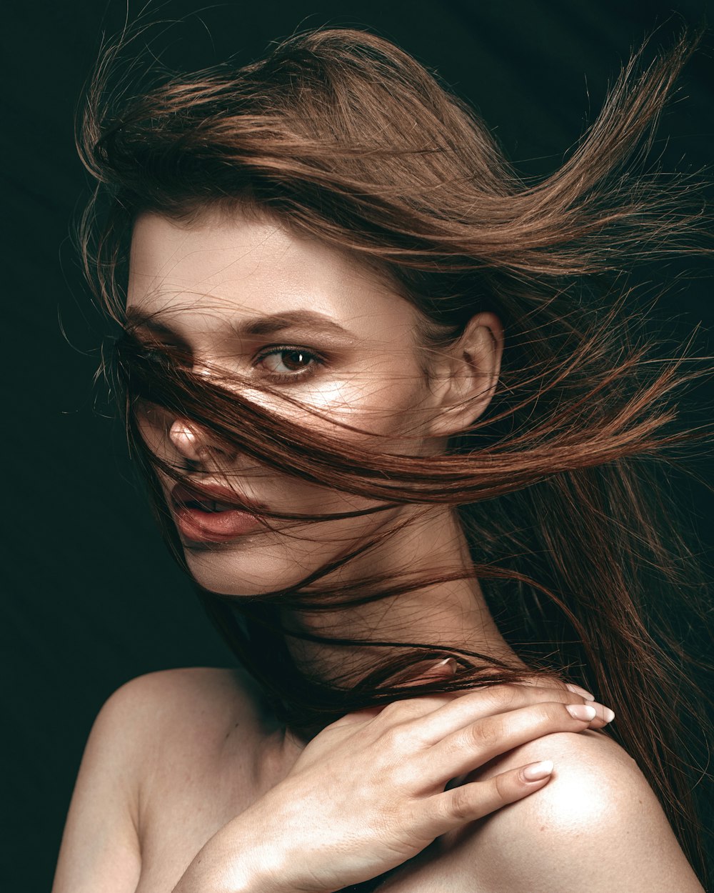 a woman with her hair blowing in the wind