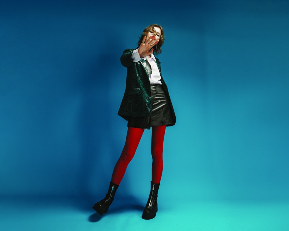 a woman in a green jacket and red tights