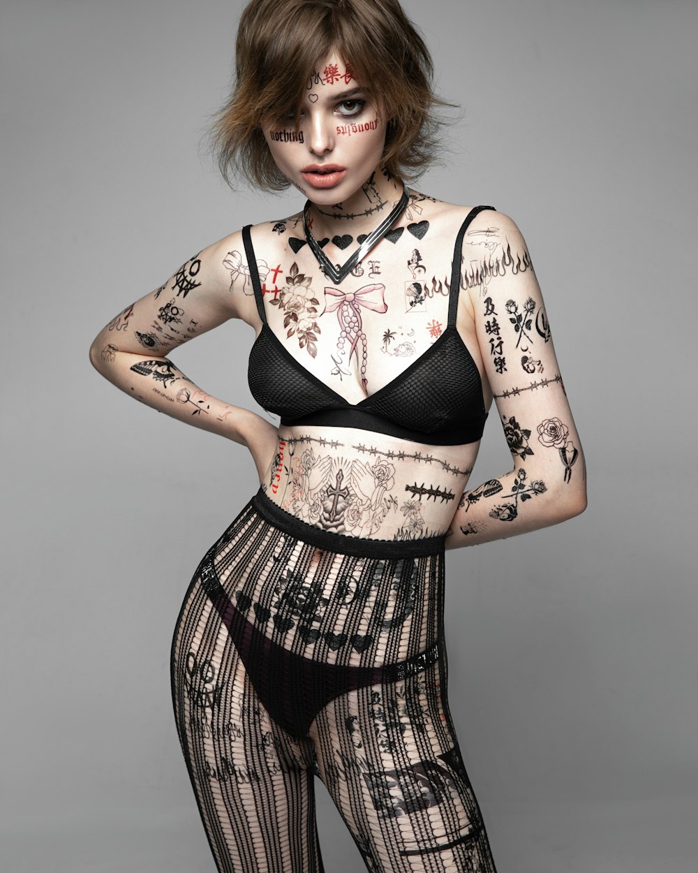 a woman with tattoos on her body posing for a picture